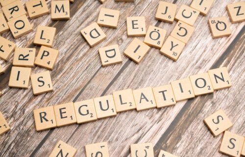 ai safety chief resigns - scrabble tiles spelling out the word regulation on a wooden surface