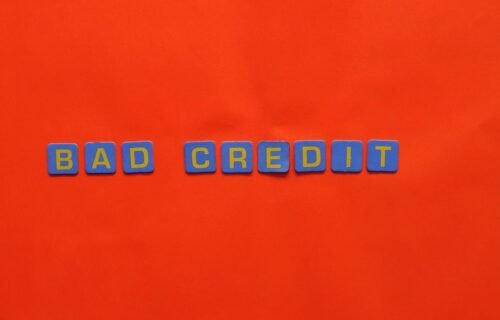 ai private credit - Blue letter blocks spelling 'Bad Credit' on an orange background.