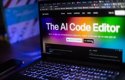 ai layoffs tech - Laptop displays "the ai code editor" website.