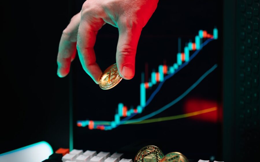 ai in banking - A hand reaching for a coin on a computer keyboard