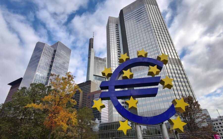 stablecoin growth - Iconic Euro sculpture with modern skyscrapers in Frankfurt, Germany showcasing the financial district.
