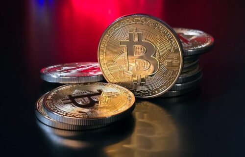 crypto scam forfeiture - a pile of bitcoins sitting on top of a table