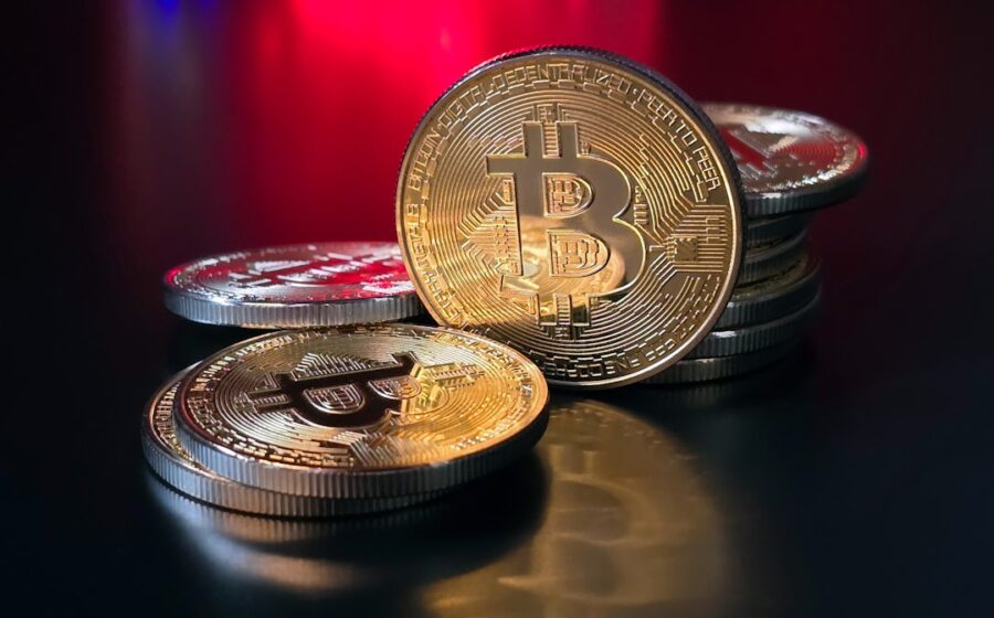 crypto scam forfeiture - a pile of bitcoins sitting on top of a table