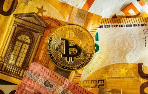 digital euro pilot - Golden Bitcoin coin placed on euro banknotes symbolizing digital currency and modern finance.