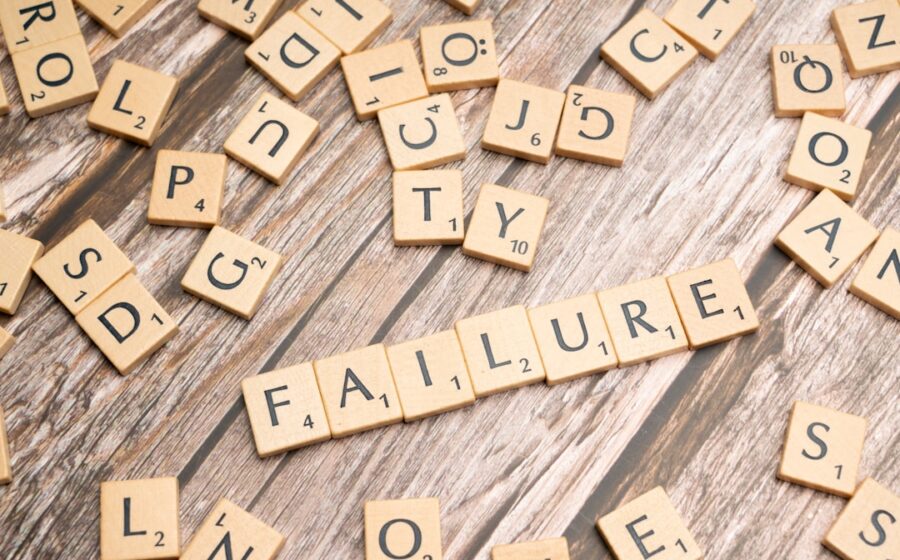 scrabble tiles spelling failure and love on a wooden surface