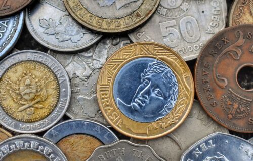 crypto aml enforcement - Top view of set of bright old metal coins with etchings and inscriptions with numbers