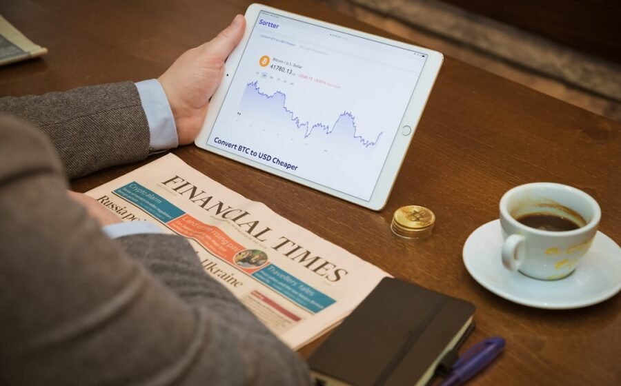 a person sitting at a table with a tablet and a cup of coffee