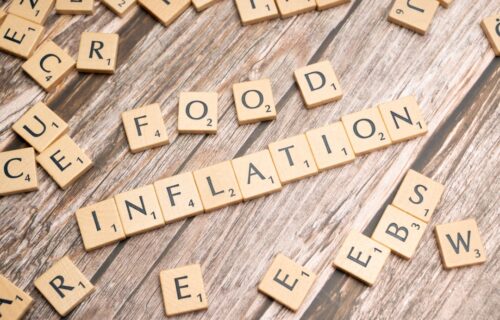 housing crisis solutions - scrabble tiles spelling out food information on a wooden table