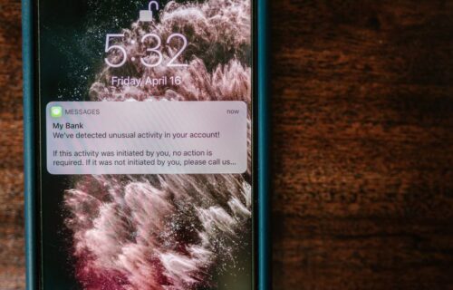 nubank mexico authorisation - Close-up of a smartphone displaying a bank alert notification on a wooden table.