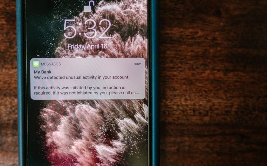 nubank mexico authorisation - Close-up of a smartphone displaying a bank alert notification on a wooden table.
