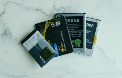 stablecoin infrastructure - Several old mobile phone batteries on a white surface