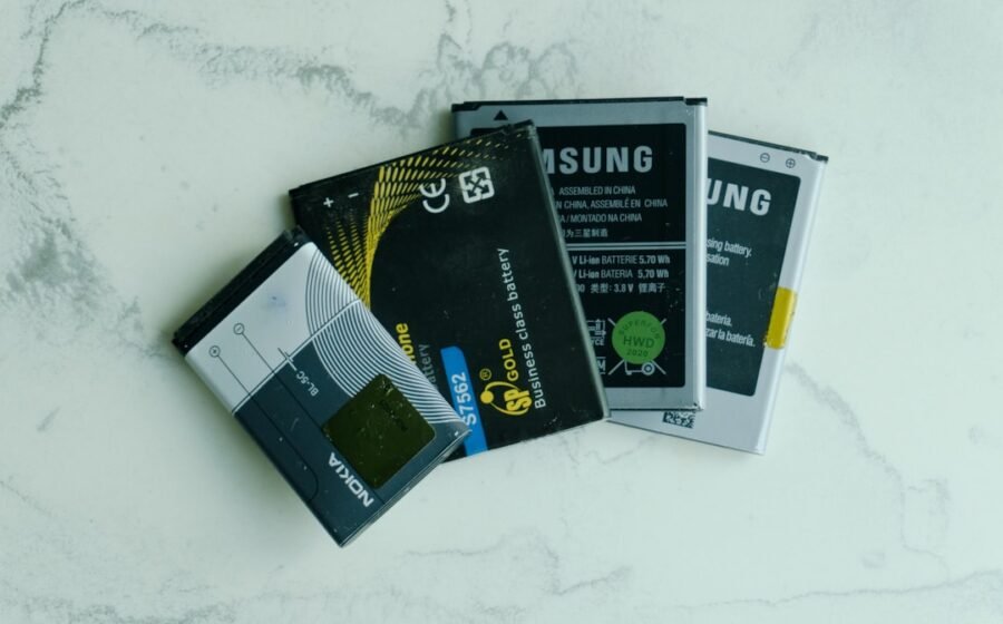 stablecoin infrastructure - Several old mobile phone batteries on a white surface