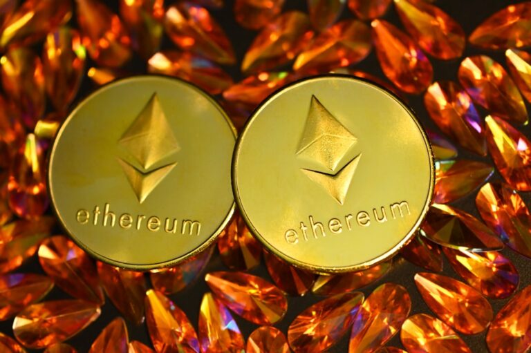 tokenized equities - two gold ethereum tokens sitting on top of a pile of crystals