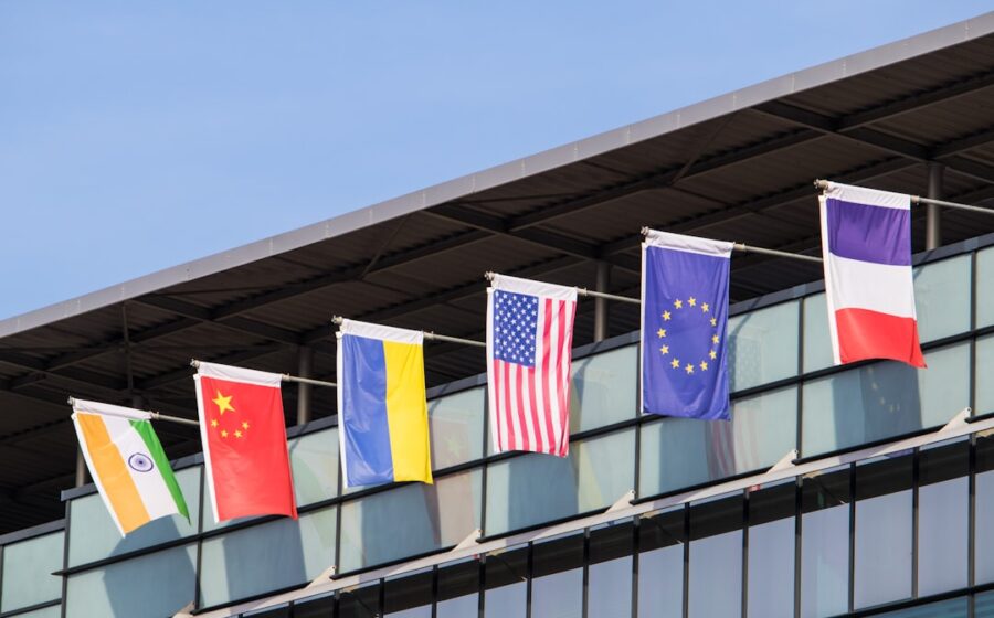 ai supremacy ban - Flags of various nations fly on building.