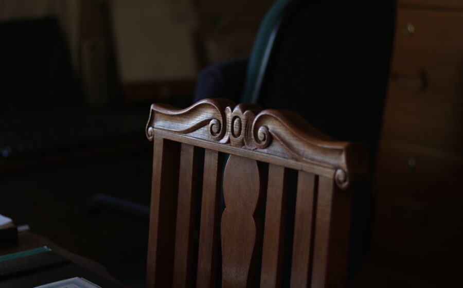fed chair warsh - brown wooden armless chair inside room