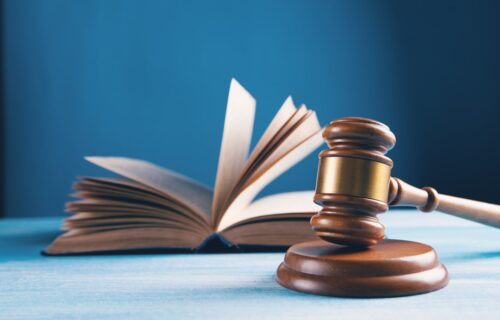judges gavel and open book on table