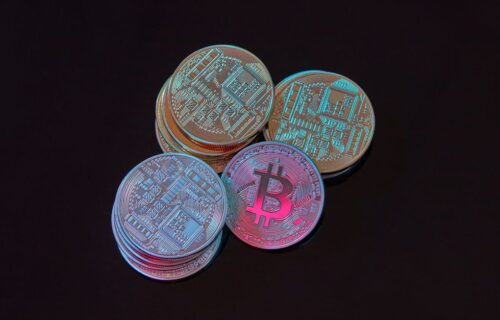CBDC central bank digital currency - A detailed image showcasing a stack of Bitcoin cryptocurrency coins on a black backgroun