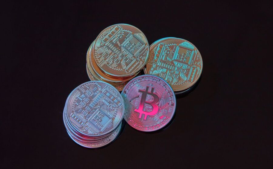 CBDC central bank digital currency - A detailed image showcasing a stack of Bitcoin cryptocurrency coins on a black backgroun