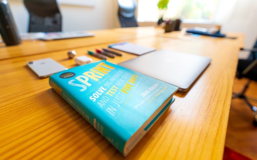 SPAC special purpose acquisition - blue and green book on brown wooden table