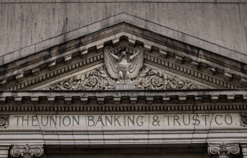 Basel III banking regulation - brown concrete building with statue