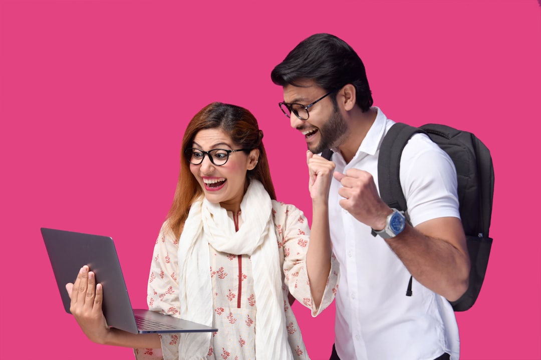 KYC know your customer - a man and a woman looking at a laptop