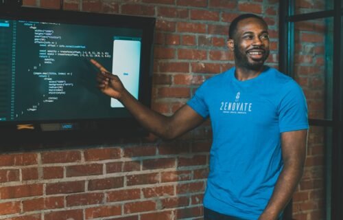 venture debt startup financing - man in blue crew neck t-shirt standing beside brown brick wall