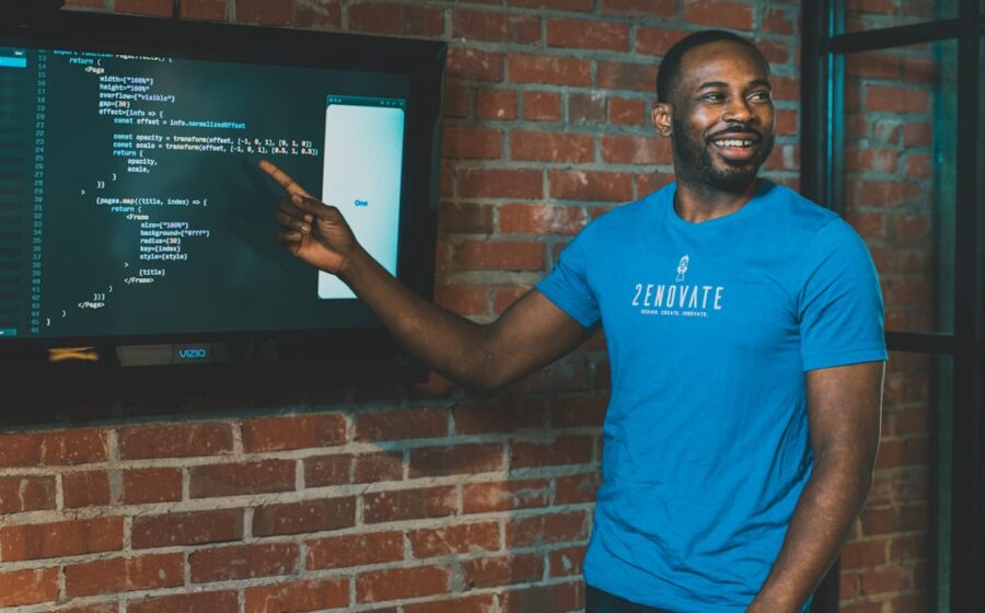 venture debt startup financing - man in blue crew neck t-shirt standing beside brown brick wall