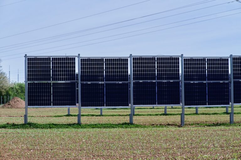 kkr renewable energy acquisition - a row of solar panels in a field