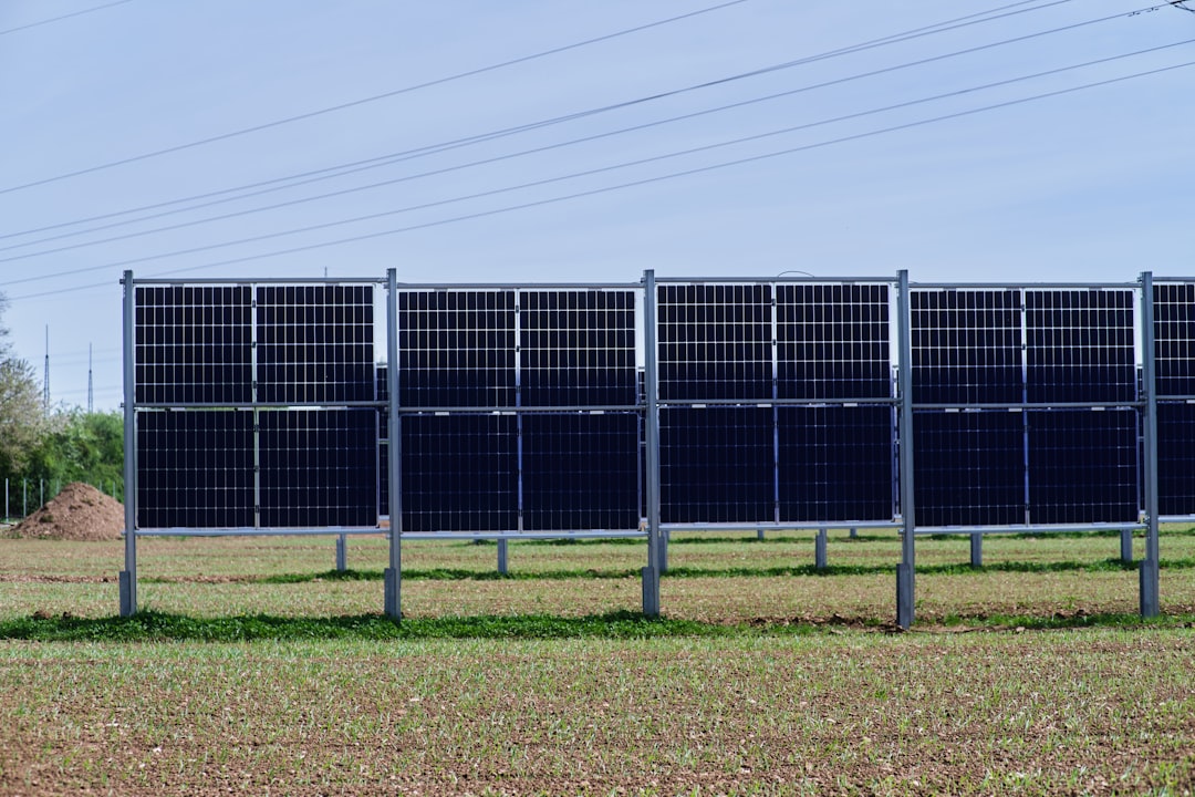 kkr renewable energy acquisition - a row of solar panels in a field