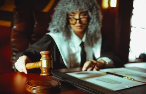 zelle fraud lawsuit - A judge in a courtroom holding a gavel, focused on legal documents.