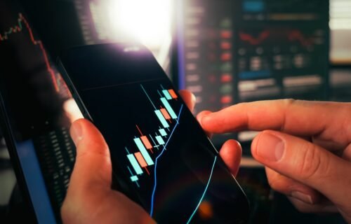 ai chip stocks - Hands holding smartphone showing stock market data