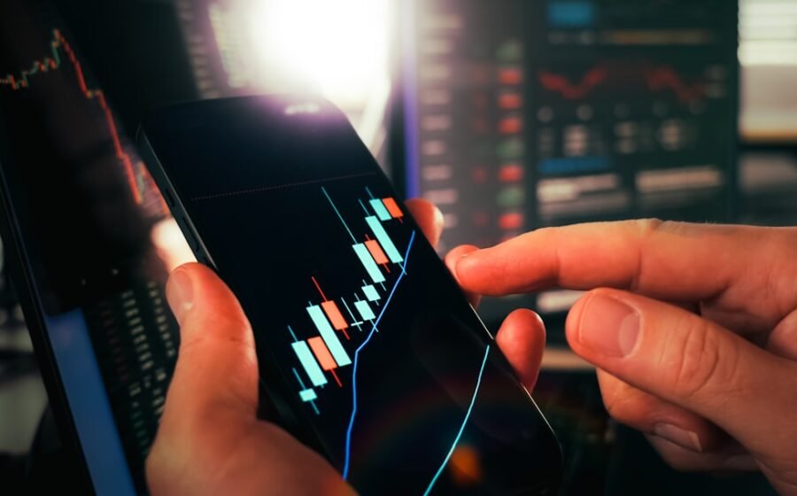 ai chip stocks - Hands holding smartphone showing stock market data