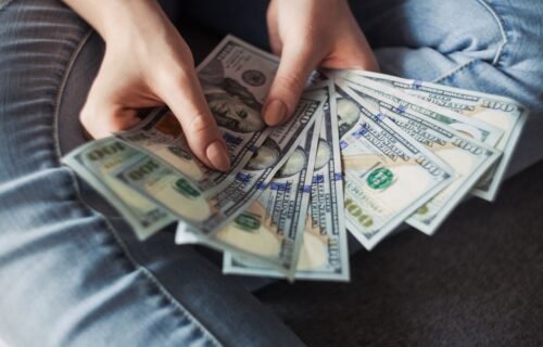 ai compute costs - fan of 100 U.S. dollar banknotes