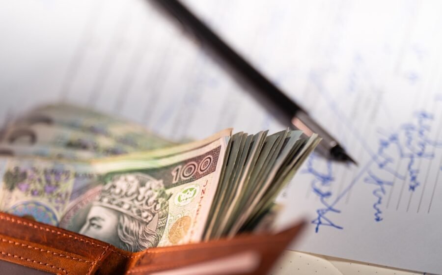 chime converts paychecks - Stack of polish zloty banknotes in a wallet.