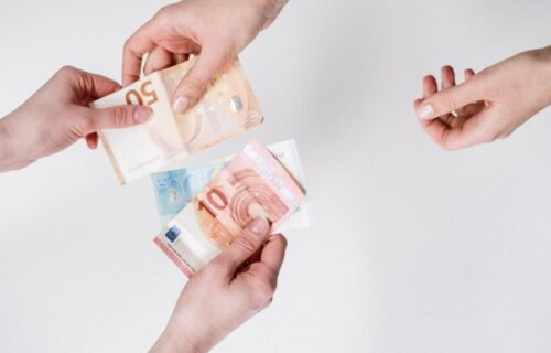 digital euro privacy - Close-up of hands exchanging euro banknotes, symbolizing currency trade and financial transactions.