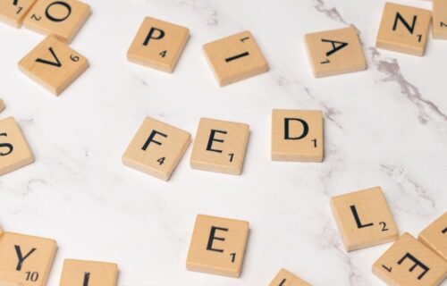 fdic consent order - Scrabble tiles arranged to spell 'FED' on a marble surface, symbolizing finance.