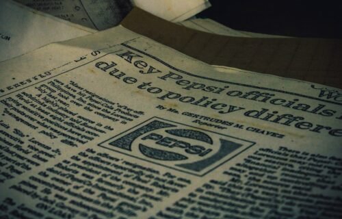 a pile of newspapers sitting on top of a table