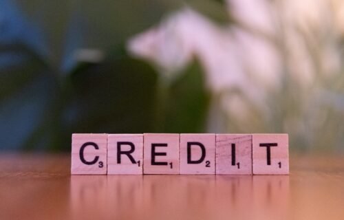 credit scoring how it works - A wooden block spelling credit on a table