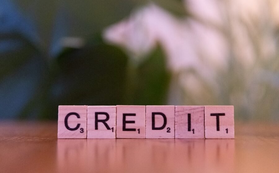 credit scoring how it works - A wooden block spelling credit on a table