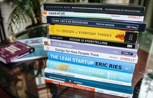 startup valuation methods - stack of books on brown wooden shelf