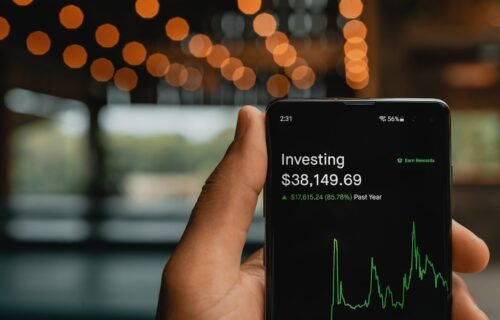 series A funding - a person holding up a cell phone with a stock chart on it