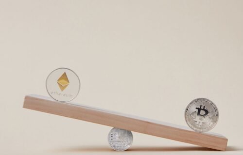 domestic stablecoins - Minimalist image of Ethereum and Bitcoin coins balancing on a plank, symbolizing crypto market dynamic
