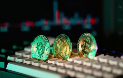 occ stablecoin reporting - Cryptocurrency coins sit on a keyboard.