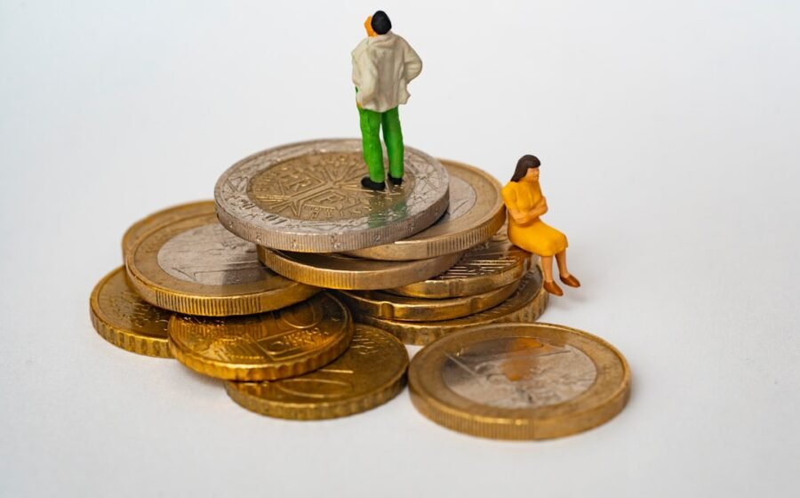 roth conversions - A miniature man and woman on a stack of gold and silver coins