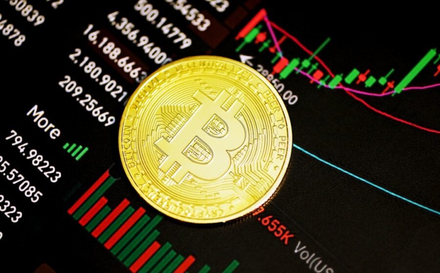 saylor sells btc - gold round coin on black surface
