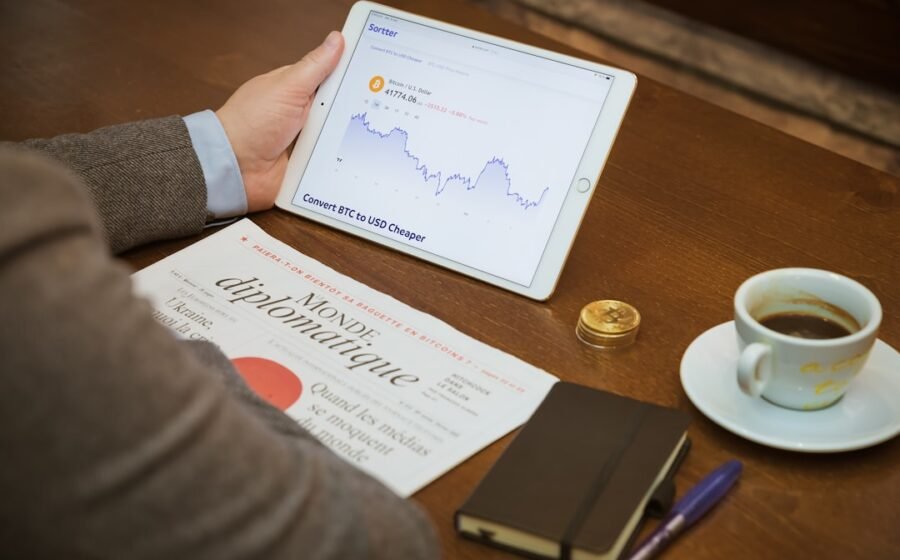 SME financing options - a person sitting at a table with a tablet and a cup of coffee
