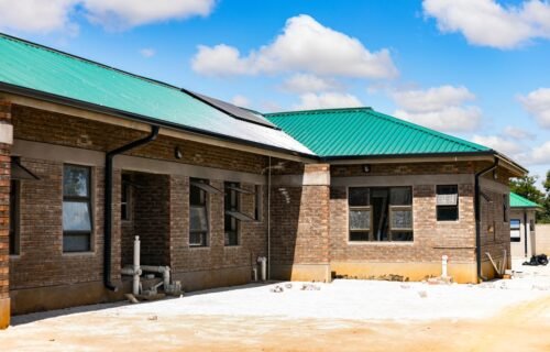 socure valuation investment - A brick building with a green metal roof under a bright blue sky
