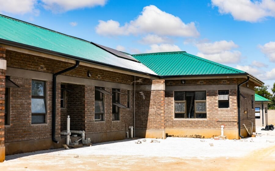 socure valuation investment - A brick building with a green metal roof under a bright blue sky