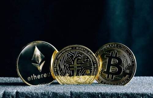 stablecoin settlement - three bitcoins sitting on top of a table