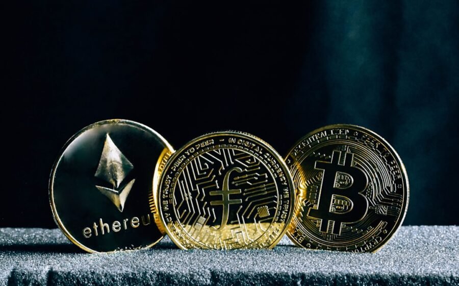 stablecoin settlement - three bitcoins sitting on top of a table